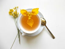 Tea in a white Cup with yellow flowers stock photography Tea in a white Cup with yellow flowers stock photography