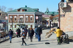 Irkutsk, Russia, March, 17, 2017. People walking in old styled 130-th quarter in Irkutsk stock image Irkutsk, Russia, March, 17, 2017. People walking in old styled 130-th quarter in Irkutsk stock image