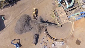 Iron raw materials recycling pile, work machines. Metal waste junkyard. Excavators diggers works on a garbage dump .View from stock video footage Iron raw materials recycling pile, work machines. Metal waste junkyard. Excavators diggers works on a garbage dump .View from stock video footage