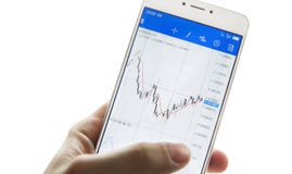Isolated businessman`s hand with a smartphone with the charts of stock exchanges Royalty Free Stock Photo Isolated businessman`s hand with a smartphone with the charts of stock exchanges Royalty Free Stock Photo