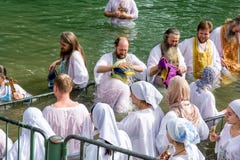 Israel / Jordan River - 03.26.2016: Christian pilgrims during the baptism ceremony on the Jordan River in Northern Israel the royalty free stock photography Israel / Jordan River - 03.26.2016: Christian pilgrims during the baptism ceremony on the Jordan River in Northern Israel the royalty free stock photography