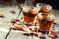 Italian Amaretto Liqueur With Dry Almonds On The Old Wooden Back Royalty Free Stock Photography
