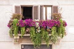 Italian balcony windows full of plants and flowers