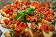 Italian bruschettas with chopped tomato and basil ready for brea stock photos Italian bruschettas with chopped tomato and basil ready for brea stock photos