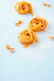Italian pasta background. Uncooked fettuccine or tagliatelle stock image Italian pasta background. Uncooked fettuccine or tagliatelle stock image