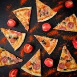 Italian pizza with ingredients. Flat lay, top view. Pizza chips pattern on dark table stock photography Italian pizza with ingredients. Flat lay, top view. Pizza chips pattern on dark table stock photography