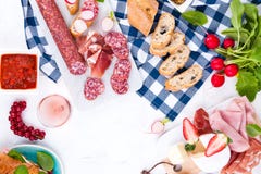 Italian salami, lots of fresh radish, strawberries and brie cheese for appetizers. Sandwiches with ciabatta various sausages, royalty free stock photo Italian salami, lots of fresh radish, strawberries and brie cheese for appetizers. Sandwiches with ciabatta various sausages, royalty free stock photo