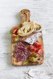 Italian Sausage, Bread Ciabatta, Olives And Cherry Tomatoes In Olive Board Royalty Free Stock Photos Italian Sausage, Bread Ciabatta, Olives And Cherry Tomatoes In Olive Board Royalty Free Stock Photos