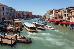 ITALY, VENICE - JULY 2012 - A Lot Of Traffic On The Grand Canal On July 16, 2012 In Venice. More Than 20 Million Tourists Come To Royalty Free Stock Image ITALY, VENICE - JULY 2012 - A Lot Of Traffic On The Grand Canal On July 16, 2012 In Venice. More Than 20 Million Tourists Come To Royalty Free Stock Image