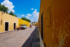 Man cycles is tricycle in a yellow street royalty free stock photos Man cycles is tricycle in a yellow street royalty free stock photos