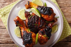 Jamaican Food: Jerk Chicken Drumstick With Lime Closeup On A Plate. Horizontal Top View From Above Royalty Free Stock Photo