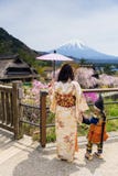 Japanese dress family with Sakura and mt. fuji Stock Images Japanese dress family with Sakura and mt. fuji Stock Images