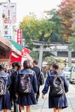Japanese school girls heading towards the main torii gate at Fushimi Inari Taisha Shrine royalty free stock image Japanese school girls heading towards the main torii gate at Fushimi Inari Taisha Shrine royalty free stock image