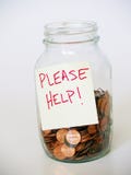 Jar full of pennies with PLEASE HELP sign