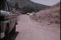 Jeep speeding down dirt road