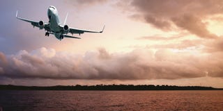 Jet Airliner Flying in an orange coloured cumulus cloudy sky. stock photos Jet Airliner Flying in an orange coloured cumulus cloudy sky. stock photos
