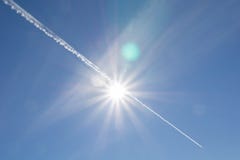 Jet stream through sun flare stock images Jet stream through sun flare stock images
