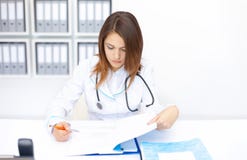 Jeune docteur féminin faisant quelques écritures dans l'hôpital photo libre de droits Jeune docteur féminin faisant quelques écritures dans l'hôpital photo libre de droits