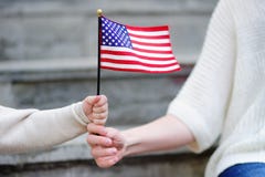 Jeune femme et petit enfant tenant le drapeau américain Image stock Jeune femme et petit enfant tenant le drapeau américain Image stock