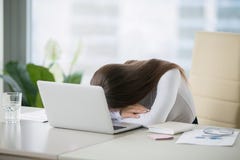 Jeune femme se trouvant au bureau près de l'ordinateur portable images stock Jeune femme se trouvant au bureau près de l'ordinateur portable images stock