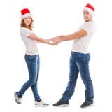 Jeunes couples tenant des mains dans des chapeaux rouges photographie stock libre de droits Jeunes couples tenant des mains dans des chapeaux rouges photographie stock libre de droits