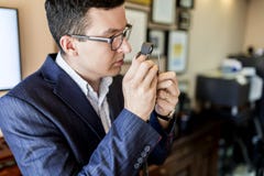 Jeweler looking at diamond through loupe Royalty Free Stock Images Jeweler looking at diamond through loupe Royalty Free Stock Images
