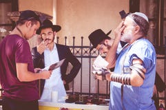 Jewish men pray on the street