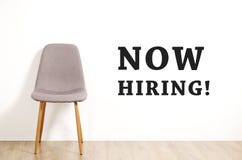 Head hunting help wanted poster concept. Minimalistic composition with chair and blank copy space wall. royalty free stock images Head hunting help wanted poster concept. Minimalistic composition with chair and blank copy space wall. royalty free stock images