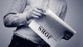 Job searching. Man seek for a job in a newspaper Job searching. Man seek for a job in a newspaper