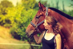 Jockey young girl petting and hugging brown horse Royalty Free Stock Photos Jockey young girl petting and hugging brown horse Royalty Free Stock Photos