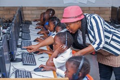 Teacher showing child how to go on internet. stock images Teacher showing child how to go on internet. stock images