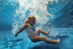 Jolie natation de petite fille dans la piscine photos stock Jolie natation de petite fille dans la piscine photos stock