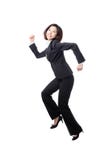 Jolis fonctionnement et saut heureux de femme d'affaires photo stock Jolis fonctionnement et saut heureux de femme d'affaires photo stock