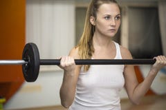 Jonge atletenvrouw die met barbell uitoefenen stock foto Jonge atletenvrouw die met barbell uitoefenen stock foto