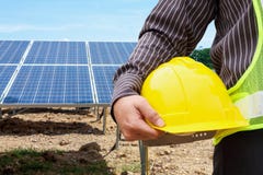 Jonge de greep gele helm van de bedrijfsmenseningenieur bij zonnepaneel stock afbeeldingen Jonge de greep gele helm van de bedrijfsmenseningenieur bij zonnepaneel stock afbeeldingen