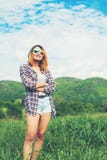 Jonge mooie hipstervrouw die gekruiste wapens in het midden van natur bevinden zich Stock Foto's Jonge mooie hipstervrouw die gekruiste wapens in het midden van natur bevinden zich Stock Foto's