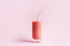 Jordgubbesmoothie eller milkshake i exponeringsglas på rosa pastellfärgad bakgrund royaltyfri bild Jordgubbesmoothie eller milkshake i exponeringsglas på rosa pastellfärgad bakgrund royaltyfri bild