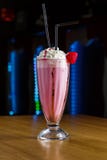 Jordgubbesmoothie med piskad kräm på en trätabell fotografering för bildbyråer Jordgubbesmoothie med piskad kräm på en trätabell fotografering för bildbyråer