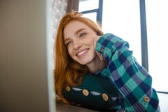 Joyful cute woman watching on monitor of laptop and laughing royalty free stock image Joyful cute woman watching on monitor of laptop and laughing royalty free stock image