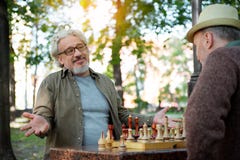 Joyful mature men enjoying chess entertainment royalty free stock photos Joyful mature men enjoying chess entertainment royalty free stock photos