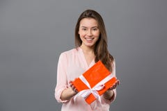 Joyful Positive Woman Holding A Gift Stock Photos Joyful Positive Woman Holding A Gift Stock Photos