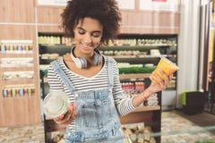 Joyful young woman is selecting meal Stock Image Joyful young woman is selecting meal Stock Image