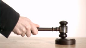 Judge in super slow motion holding a gavel