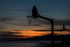Jugar baloncesto en la puesta del sol fotos de archivo libres de regalías Jugar baloncesto en la puesta del sol fotos de archivo libres de regalías
