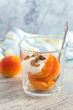 Juicy Peach With Plums And Nuts In A Glass On A Table With A Striped Napkin. Royalty Free Stock Photography Juicy Peach With Plums And Nuts In A Glass On A Table With A Striped Napkin. Royalty Free Stock Photography