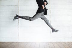 Jumping man in black costume in the office stock photos Jumping man in black costume in the office stock photos