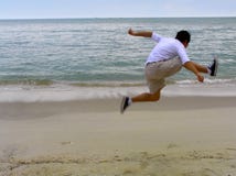 Jumping On The Beach Stock Image