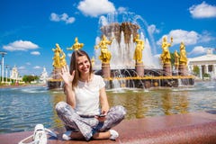 Junge Schönheit hat einen Rest, der nahe dem Brunnen sitzt lizenzfreie stockfotografie Junge Schönheit hat einen Rest, der nahe dem Brunnen sitzt lizenzfreie stockfotografie