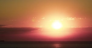 4K timelapse with the sun rising over a beach on the Black Sea coast of Bulgaria during a hot summer day.