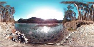 360 VR virtual reality of a wild mountains, pine forest and river flows. National park, meadow and sun rays. stock footage 360 VR virtual reality of a wild mountains, pine forest and river flows. National park, meadow and sun rays. stock footage